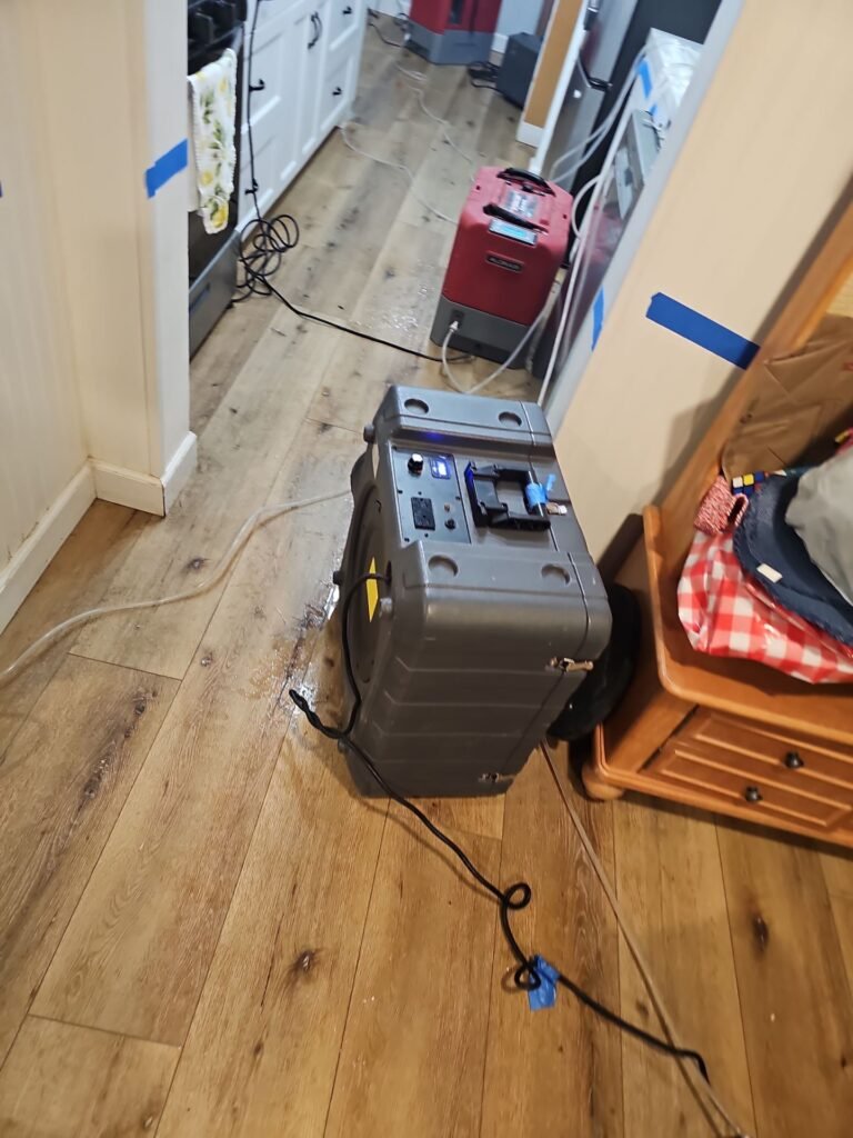 Water extraction underway in a hallway after a pipe failure
