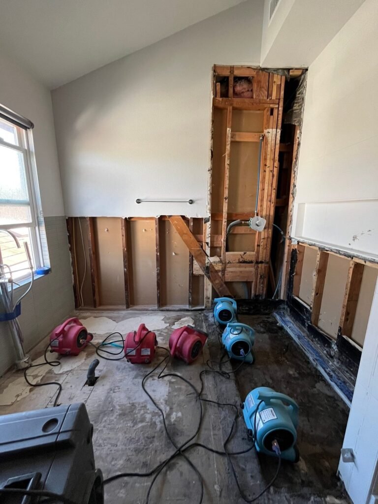 A vaulted bedroom with the wall opened and five air movers running